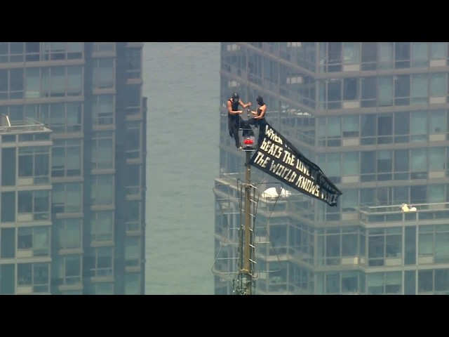 Two People Climb Empire State Building With Banner