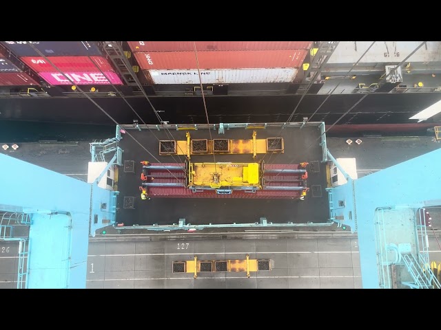 Loading containers on deck in windy conditions with a Gantry Crane.