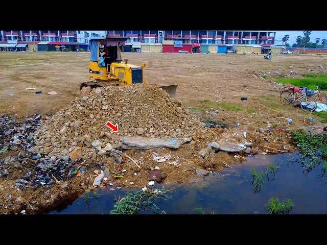 Start new project in rain dozer D31 repair road to fill land delete flooded field with dump truck