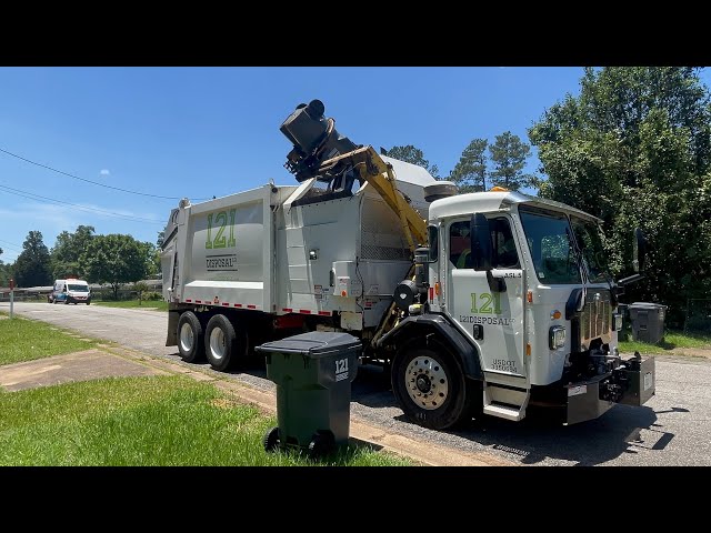 121 Disposal Kenworth L770 Heil python side loader garbage truck packing out near the river 