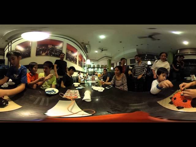 Thai blowing his birthday cake with the familiy
