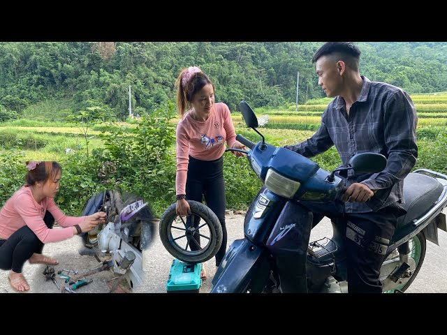 Rural scene: The girl repaired an old motorbike for the farmer.