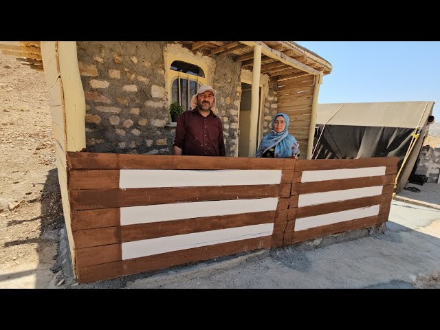 New paint on the porch of the stone house; what changes did Ahmad make this time?
