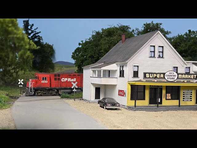 CP Rail Train 937 passes Joe's Super Market at Richford, VT on a warm summer afternoon in 1980. 