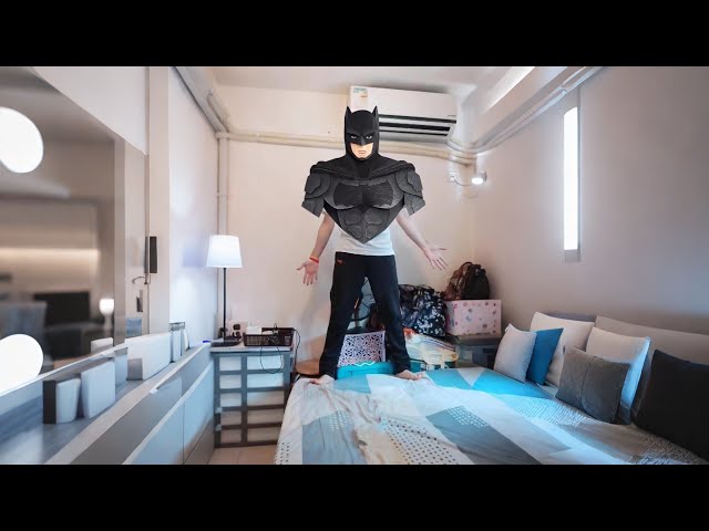 Cardboard Batman armor built outside Gotham—a hero's legend.
