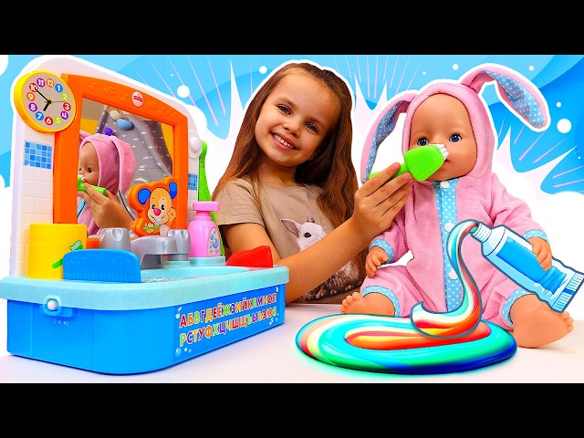 Maya brushes teeth with a baby doll and takes care of them.