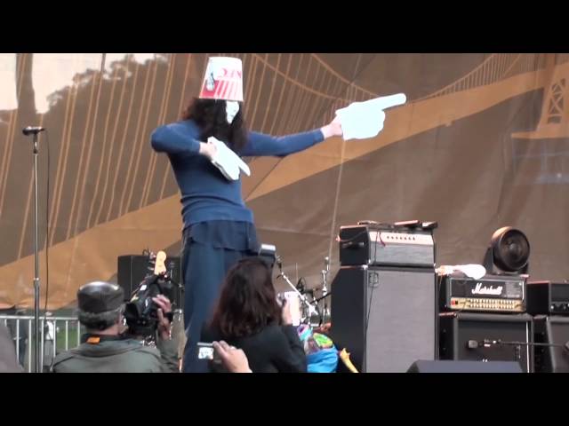 Buckethead playing with nunchucks and doing the robot on stage