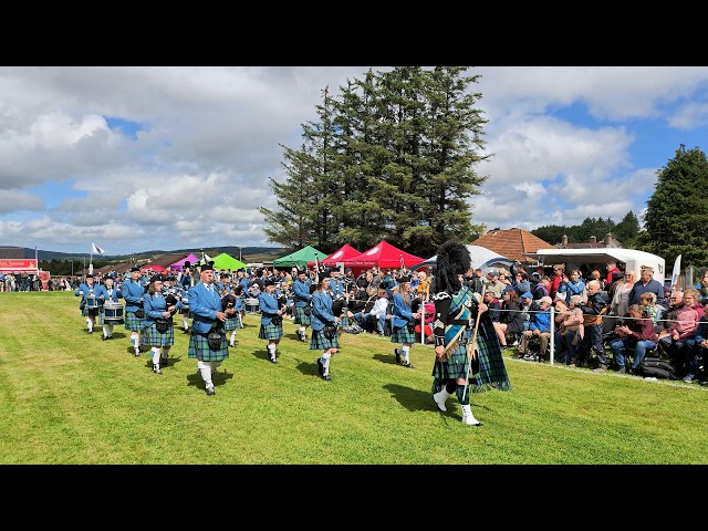 Drum Major Coull leads Buckie Pipe Band march during the 2026 Dufftown Highland Games in Scotland
