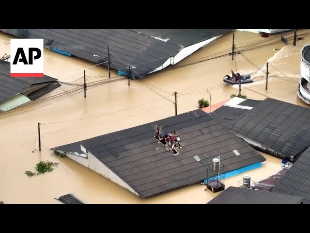 Video shows workers rescuing a family from rooftop in Thailand flooding