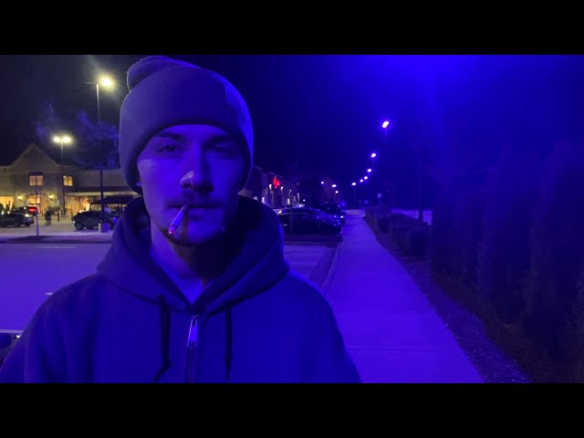 Smoking a Cigarette Under the Purple Hue of a Defective Street Light