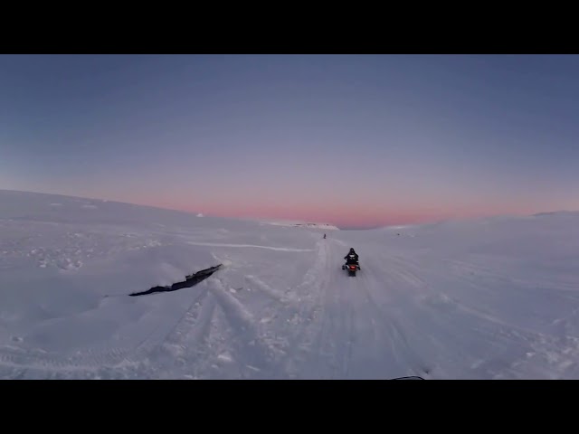 Snow moto on a glacier during sunset in Iceland