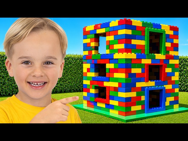 Kids play with colored toy blocks and build Three Level House