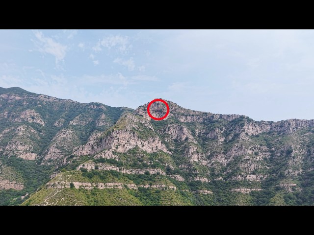 A house hangs precariously on the cliff face, hiding a strange and ancient legend.