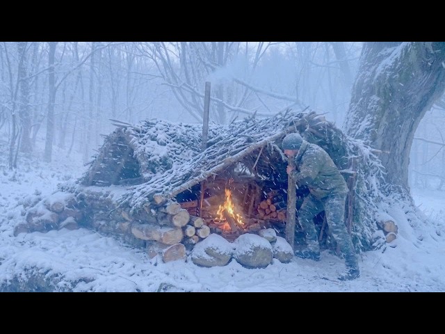 Bushcraft in a Snowstorm: Building a wilderness survival shelter from branches under a tree