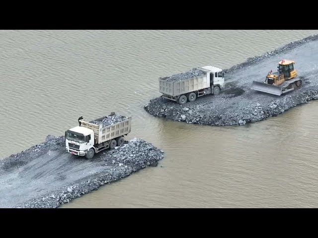 Contact Construction of a road across the lake is almost , dozer Pushing Stone & Truck 25.5Ton 
