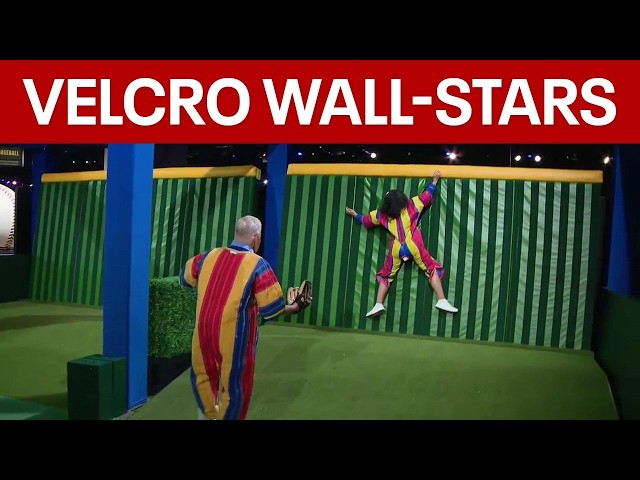 Alex and Mike try the velcro wall at MLB All-Star Village