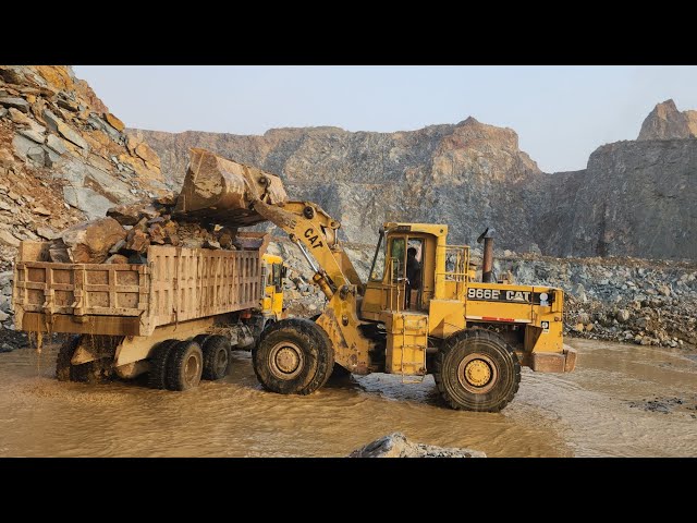 Power and Precision of Caterpillar 966E Wheel Loader: Loading Stone into Dump Trucks