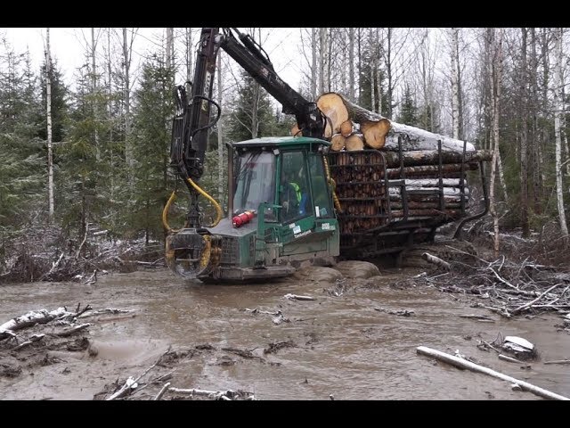 Timberjack 810B logging in wet winter forest