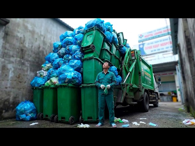 Rear-loading garbage truck confronts trash at town hospital.