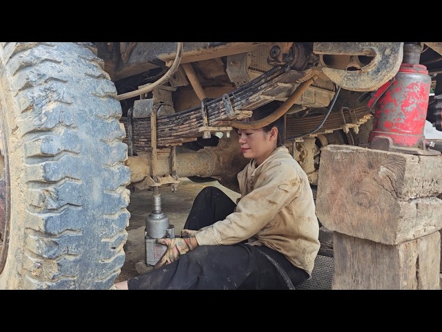 Female auto mechanic: replacing a truck leaf spring snapped in two