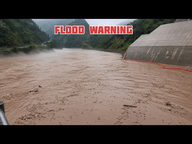 Massive volume of sediments released as the dam spillway gate opens before the storm
