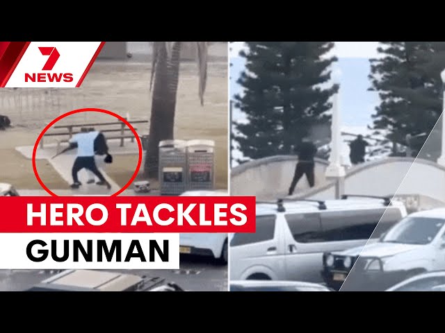 Incredible footage shows hero tackling gunman at Bondi beach shooting | 7NEWS