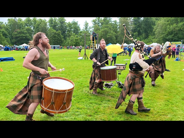 Thundering drums of Clann An Drumma playing in rain during 2026 Luss Highland Gathering in Scotland