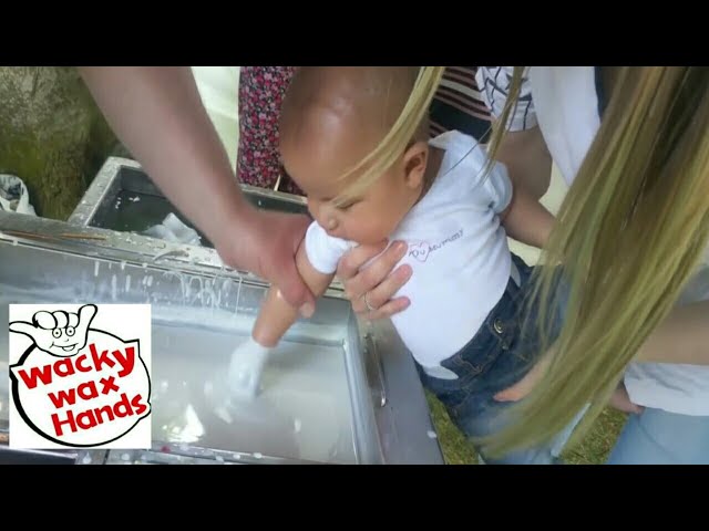 Dipping Babies Hand in Wax.   Babies keepsake idea.
