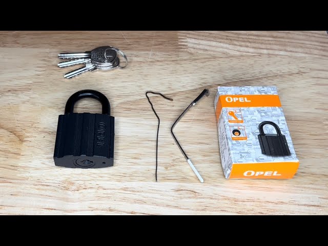 1184. Opel 38mm padlock picked open with a homemade lock pick bra wire tension tool and a hair grip