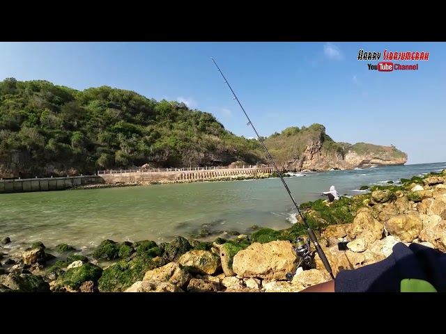 The little boy was fishing and was still excited waiting for the fish to bite